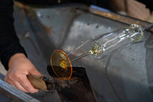 Load image into Gallery viewer, Artisan crafting a mouth-blown Amphitrite champagne flute using traditional glassblowing techniques.
