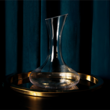 Load image into Gallery viewer, Empty Katie Jayne Signature wine decanter, pictured on a golden tray in dark and intimate lighting, in-front of a blue curtain. 
