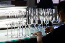 Load image into Gallery viewer, Amphitrite champagne flutes undergoing a quality check in the production stage.
